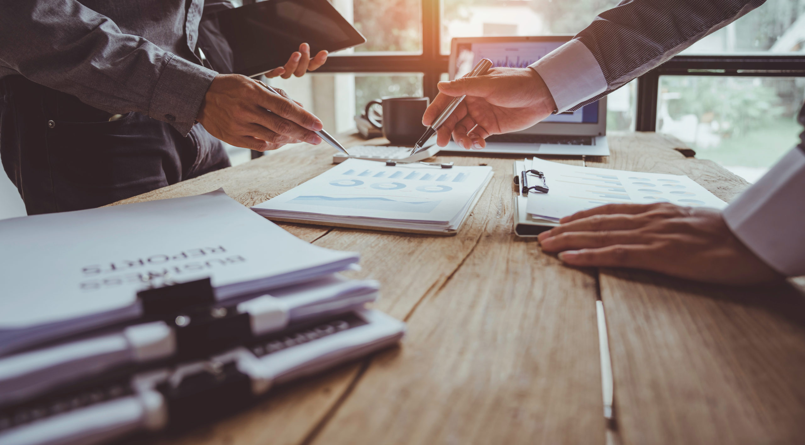 AdobeStock_504829031_MaleHandsPrintedReports-scaled-1